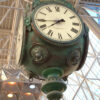 View from the bottom of the post clock, featuring cast lion heads and intricate details.