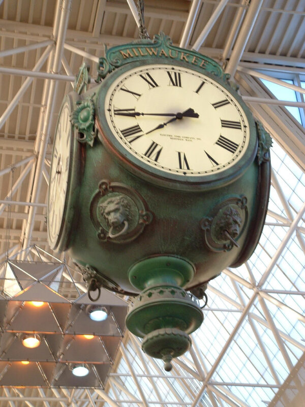 View from the bottom of the post clock, featuring cast lion heads and intricate details.