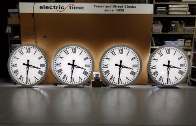 Four illuminated tower clocks being manufactured in a factory