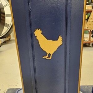 Close-up view of the custom chicken silhouette design featured on the side of a post clock. Close-up of chicken silhouette logo detail on a post clock