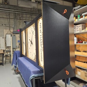 Final inspection of the completed Bank of New Hampshire McClintock-style clock before shipment.