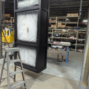 McClintock-style exterior bracket bank clock undergoing painting and finishing in the factory.