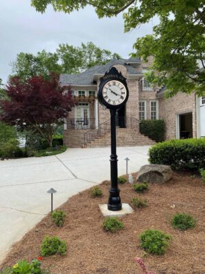A classic residential street clock with two dials on a post design